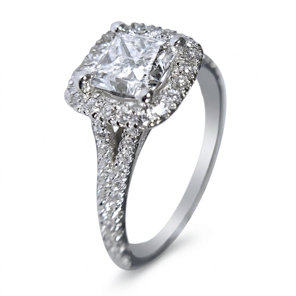 A princess cut diamond halo ring in white gold metal with pavé-set diamonds on the band